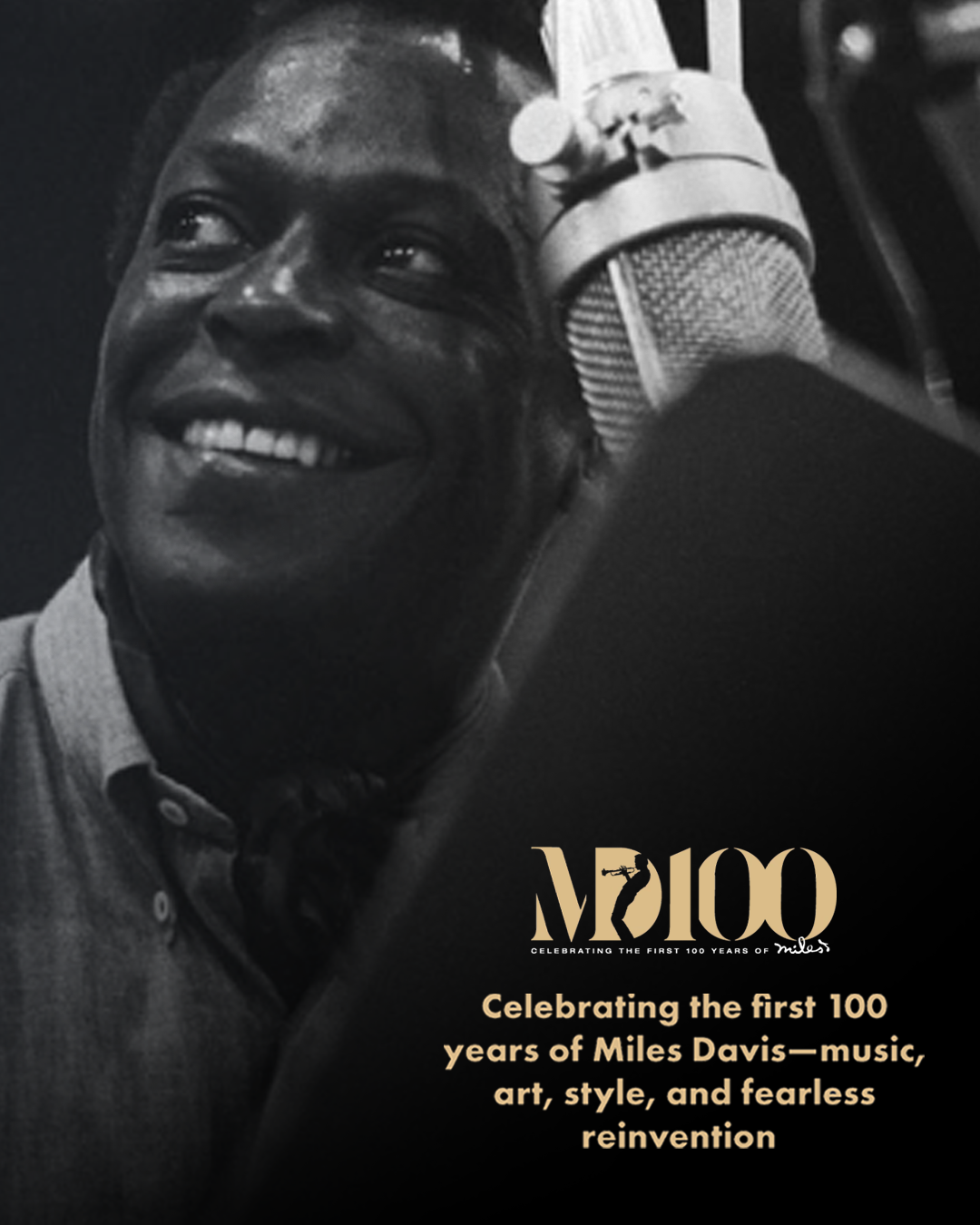 Black and white photo of a person smiling with a microphone, celebrating Miles Davis' 100th year.